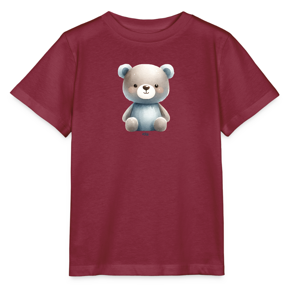 Das Bild zeigt ein rotes Kinder-T-Shirt, das in der Mitte ein niedliches Bärchenmotiv aufgedruckt hat. Der Bär ist in sanften Farbtönen gehalten, mit einem grauen Kopf und einem blauen Körper. Die Augen des Bärchens sind groß und freundlich, was dem Shirt ein verspieltes Aussehen verleiht. Das T-Shirt hat kurze Ärmel und einen klassischen Schnitt, ideal für den Alltag von Kindern.