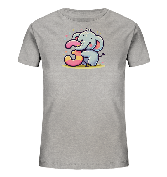 Onlineshop Shirts fuer Kinder - Das Bild zeigt ein graues Kinder-T-Shirt mit einem niedlichen Cartoon-Elefanten auf der Vorderseite. Der Elefant haelt die grosse, bunt gestreifte Zahl 3 mit seinem Ruessel fest. Kleine, farbige Punkte sind um das Motiv herum verstreut, was dem Design einen froehlichen Charakter verleiht. Die Illustration ist verspielt und ansprechend fuer junge Traeger.