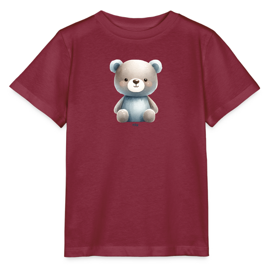 Das Bild zeigt ein rotes Kinder-T-Shirt, das in der Mitte ein niedliches Bärchenmotiv aufgedruckt hat. Der Bär ist in sanften Farbtönen gehalten, mit einem grauen Kopf und einem blauen Körper. Die Augen des Bärchens sind groß und freundlich, was dem Shirt ein verspieltes Aussehen verleiht. Das T-Shirt hat kurze Ärmel und einen klassischen Schnitt, ideal für den Alltag von Kindern.