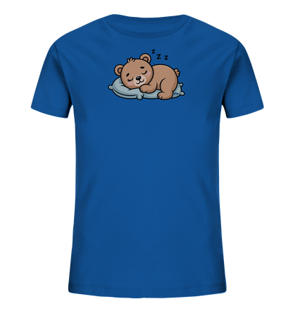 Onlineshop Shirts fuer Kinder - Das Bild zeigt ein koenigsblaues Kinder-T-Shirt mit einem niedlichen Aufdruck eines schlafenden Baeren. Der braune Cartoon-Baer liegt friedlich auf einem hellblauen Kissen, die Augen geschlossen und ein leichtes Laecheln im Gesicht, begleitet von 'Z Z Z'-Symbolen. Das Design ist verspielt und vermittelt eine beruhigende Atmosphaere, ideal fuer kleine Schlafmuetzen.