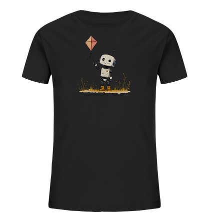 Onlineshop Shirts für Kinder - Das Bild präsentiert ein schwarzes Kinder-T-Shirt mit einer farbigen Grafik auf der Vorderseite. Die Illustration zeigt einen kleinen, weiß-grauen Roboter mit einem freundlichen Gesichtsausdruck, der in einer Wiese steht. Der Roboter hält die Schnur eines orangefarbenen Drachens, der über ihm in die Höhe steigt. Dieses verspielte Motiv ist detailliert gestaltet und setzt einen lebhaften Akzent auf dem dunklen Stoff des Shirts.