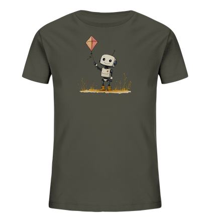 Onlineshop Shirts für Kinder - Das Bild zeigt ein dunkelgraues T-Shirt für Kinder mit einem farbigen Druck auf der Vorderseite. Das Motiv stellt einen kleinen, freundlichen Roboter im Comic-Stil dar, der einen roten, rautenförmigen Drachen in der Hand hält. Der Roboter steht auf einem Streifen stilisierten Grases mit kleinen, bunten Details. Das Design wirkt fröhlich und verspielt, passend für Kinderbekleidung.