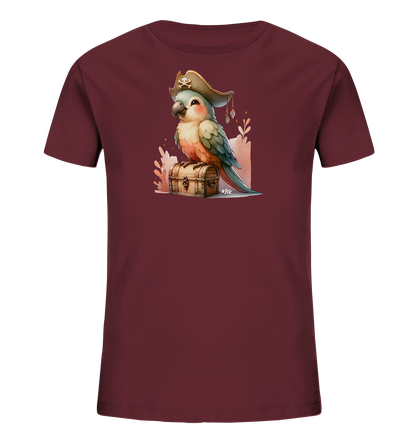 Onlineshop Shirts fuer Kinder - Dieses dunkelrote T-Shirt zeigt eine bezaubernde Illustration eines Papageis mit Piratenhut. Der Vogel sitzt auf einer detailreichen Holz-Schatzkiste, umgeben von dekorativen Pflanzenmotiven. Das farbenfrohe und verspielte Design macht es zu einem Highlight.