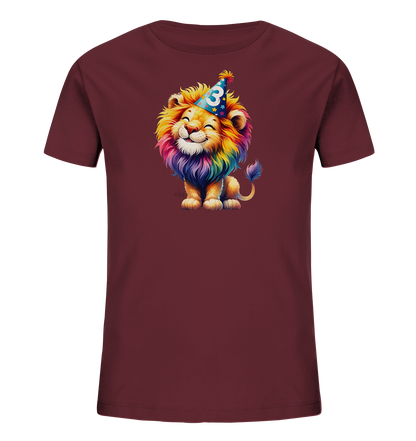 Onlineshop Shirts fuer Kinder - Das Bild zeigt ein weinrotes Kinder-T-Shirt mit einem froehlichen Aufdruck auf der Vorderseite. Ein bunter Cartoon-Loewe mit einer regenbogenfarbenen Maehne und einem freundlichen Laecheln ist abgebildet. Der Loewe traegt einen blauen Partyhut, der mit Sternen und der Zahl '3' verziert ist. Die Grafik hat einen lebendigen und bunten Stil.