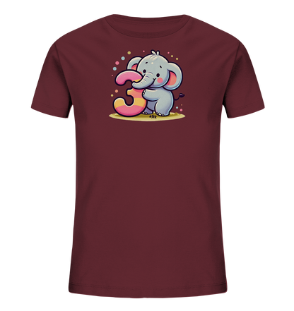 Onlineshop Shirts fuer Kinder - Das Bild zeigt ein weinrotes Kinder-T-Shirt mit einem niedlichen Druck auf der Vorderseite. Die Illustration zeigt einen grauen Cartoon-Elefanten, der eine grosse, mehrfarbige Zahl '3' umarmt. Kleine, bunte Punkte sind um das Motiv herum verteilt und sorgen fuer eine froehliche Atmosphaere. Das Design ist verspielt und passend fuer einen dritten Geburtstag.