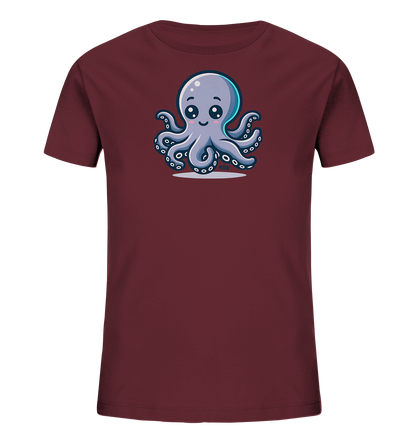 Onlineshop Shirts fuer Kinder - Das Bild zeigt ein dunkelrotes Kinder-T-Shirt. Auf der Vorderseite ist eine niedliche, cartoonartige Illustration eines Oktopus zu sehen. Der Oktopus ist lila-grau, hat grosse, freundliche Augen und laechelt mit rosa Wangen. Er sitzt aufrecht mit ausgebreiteten Tentakeln, die Saugnaepfe zeigen.