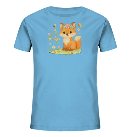 Onlineshop Shirts fuer Kinder - Das Bild zeigt ein hellblaues Kinder-T-Shirt mit einer niedlichen Illustration. Darauf ist ein freundlicher Fuchs mit Blumenkranz zu sehen, der auf einer Wiese sitzt. Umgeben ist der Fuchs von Blumen, einer Biene und einem Schmetterling. Eine verspielte Vier aus Blumen und Blaettern ist ebenfalls Teil des Designs.