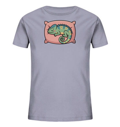 Onlineshop Shirts fuer Kinder - Das Bild zeigt ein hellviolettes Kinder-T-Shirt mit einem niedlichen Aufdruck eines schlafenden Chamaeleons. Das Chamaeleon ist gruen-blau gefaerbt mit gelben Akzenten und liegt eingerollt auf einem rosafarbenen Kissen. Es hat die Augen geschlossen und wirkt friedlich schlafend. Das Design ist verspielt und farbenfroh, ideal fuer Kinder.