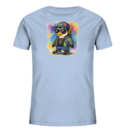 Onlineshop Shirts fuer Kinder - Das Bild zeigt ein hellblaues T-Shirt fuer Kinder. Es ist mit einer Cartoon-Illustration eines Pinguins verziert, der Sonnenbrille, Kappe und Kopfhoerer traegt. Der Pinguin ist in bunter Kleidung mit Sternen abgebildet und steht vor einem farbenfrohen Aquarellhintergrund. Das Design wirkt verspielt und modern.