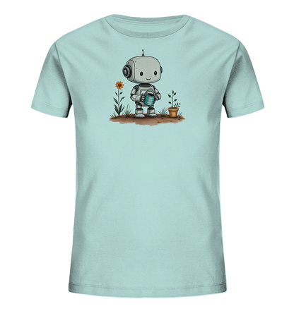 Onlineshop Shirts für Kinder - Das Bild zeigt ein hellblaues T-Shirt mit einem freundlichen, cartoonartigen Roboter-Motiv auf der Vorderseite. Der kleine Roboter hält eine blaue Gießkanne in den Händen und scheint gerade eine kleine Pflanze in einem Terrakottatopf zu gießen. Neben der Pflanze wächst eine einzelne Blume mit orangefarbenen Blütenblättern und grünen Stängeln und Blättern aus dem Boden. Das Design ist verspielt und thematisiert das Gärtnern auf eine kindgerechte Weise.