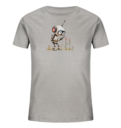 Onlineshop Shirts für Kinder - Das Bild zeigt ein graues Kinder-T-Shirt mit einem Aufdruck auf der Vorderseite. Der Aufdruck stellt einen kleinen, weißen Roboter mit roten und blauen Details sowie einer Antenne dar. Der Roboter hält eine Lupe in einer Hand und betrachtet damit eine Pflanze, die inmitten von Gräsern und kleineren Blumen steht. Das gesamte Motiv ist detailliert gezeichnet und vermittelt eine neugierige und naturverbundene Stimmung.