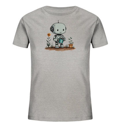 Onlineshop Shirts für Kinder - Das Bild zeigt ein hellgraues Kinder-T-Shirt mit einem aufgedruckten Motiv auf der Vorderseite. Das Motiv stellt einen kleinen, freundlich lächelnden Roboter dar, der eine blaue Gießkanne hält. Neben dem Roboter wächst eine einzelne, orangefarbene Blume aus dem Boden sowie eine kleine Topfpflanze. Der Hintergrund des Motivs simuliert braune Erde, was dem Design einen natürlichen Touch verleiht.