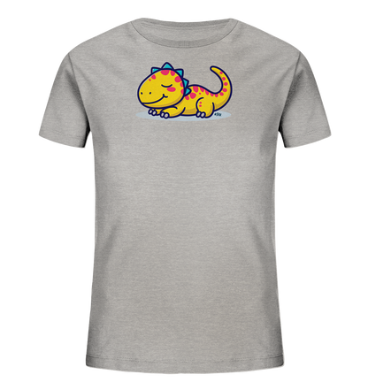 Onlineshop Shirts fuer Kinder - Das Bild zeigt ein hellgraues Kinder-T-Shirt. Auf der Vorderseite befindet sich eine niedliche, gelbe Cartoon-Dinosaurier-Illustration. Der Dino hat pinke Punkte und blaue Zacken, liegt entspannt da und hat einen freundlichen Ausdruck. Das Design verleiht dem Shirt einen verspielten und charmanten Charakter.