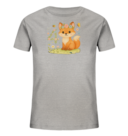 Onlineshop Shirts fuer Kinder - Das Bild zeigt ein graues Kinder T-Shirt mit einem niedlichen Fuchs-Motiv auf der Vorderseite. Der Fuchs traegt einen Blumenkranz und sitzt auf einer Wiese, umgeben von farbenfrohen Blumen, einer Biene und einem Schmetterling. Das Design ist liebevoll gezeichnet und strahlt eine freundliche, verspielte Atmosphaere aus.