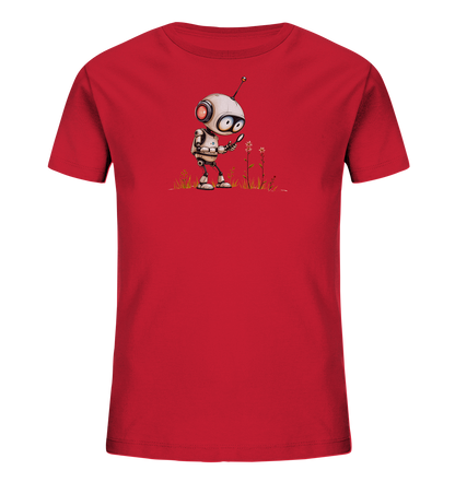 Onlineshop Shirts für Kinder - Das Bild zeigt ein rotes Kinder-T-Shirt, das auf der Vorderseite bedruckt ist. Das Design zeigt einen kleinen, weißen Roboter mit roten Akzenten und einer Antenne auf dem Kopf. Der Roboter steht auf einer angedeuteten Wiese mit Gras und kleinen rosa Blüten und hält eine Lupe in der Hand, mit der er eine Blume untersucht. Die Illustration vermittelt eine Szene der Entdeckung oder Neugier.