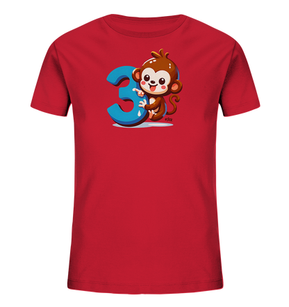 Onlineshop Shirts fuer Kinder - Das Bild zeigt ein rotes T-Shirt fuer Kinder. Auf der Vorderseite ist eine lustige Cartoon-Illustration. Sie zeigt einen braunen Affen, der die grosse blaue Zahl '3' umarmt. Der Affe laechelt freundlich und sitzt auf einer stilisierten blauen Flaeche.