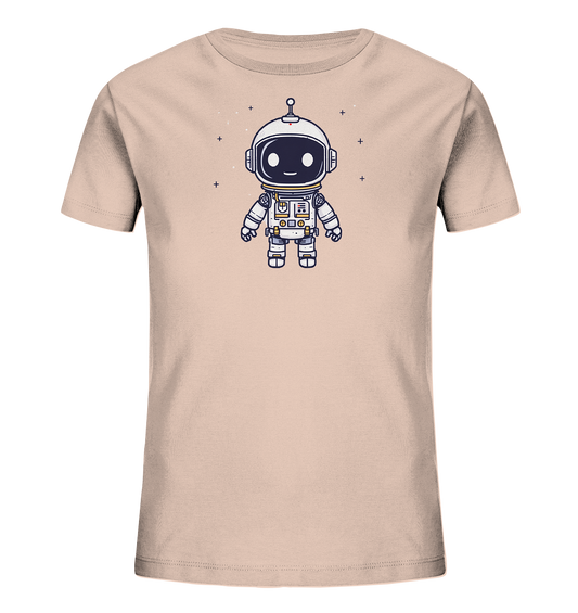 Onlineshop Shirts für Kinder - Das Bild zeigt ein kurzärmeliges Kinder-T-Shirt in einem hellen Beigeton. Auf der Vorderseite ist eine niedliche, cartoonartige Illustration eines kleinen Astronauten abgebildet. Der Astronaut trägt einen weißen Raumanzug mit grauen Details und hat ein großes Helmvisier, das schwarze Augen und einen gelben Mund zeigt, was ihm ein freundliches Aussehen verleiht. Um die Figur herum sind kleine weiße Pluszeichen verteilt, die Sterne im Weltraum darstellen.