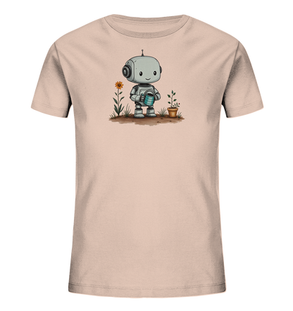 Onlineshop Shirts für Kinder - Das Bild zeigt ein cremefarbenes Kinder-T-Shirt mit einem niedlichen, cartoonhaften Roboter-Motiv auf der Vorderseite. Der kleine Roboter steht auf brauner Erde und hält eine blaue Gießkanne in seinen Händen. Rechts neben ihm steht ein brauner Blumentopf mit einer jungen Pflanze, die er gerade zu gießen scheint. Links vom Roboter wächst eine orangefarbene Blume an einem grünen Stiel, was die Szene eines kleinen Roboters bei der Gartenarbeit darstellt.