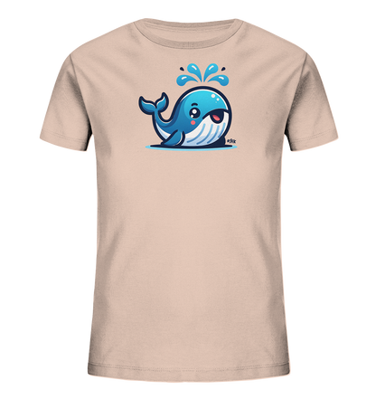 Onlineshop Shirts fuer Kinder - Das Bild zeigt ein beiges Kinder-T-Shirt mit einem niedlichen, cartoonhaften Walmotiv. Der blaue Wal lacht und spritzt Wasser aus seinem Blasloch in die Luft. Die Illustration hat grosse Augen und wirkt sehr freundlich. Das Design ist verspielt und farbenfroh, ideal fuer Kinder.
