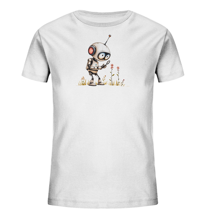 Onlineshop Shirts für Kinder - Das Bild zeigt ein weißes T-Shirt für Kinder. Auf der Vorderseite ist eine bunte Grafik abgebildet, die einen kleinen, cartoonartigen Roboter darstellt. Der Roboter steht im Gras und betrachtet mit einer Lupe zwei rosafarbene Blumen. Das Design ist mittig auf dem Shirt platziert und vermittelt eine neugierige und freundliche Stimmung.