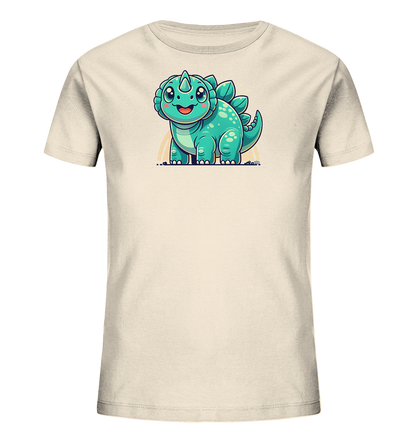 Onlineshop Shirts fuer Kinder - Dieses T-Shirt in hellem Beige zeigt eine niedliche Illustration eines laechelnden, tuerkisfarbenen Dinosauriers. Der Cartoon-Dino hat grosse Augen, Stacheln auf dem Ruecken und wirkt sehr freundlich. Eine leichte Aura oder Glanz umgibt die Figur, was das Design hervorhebt.