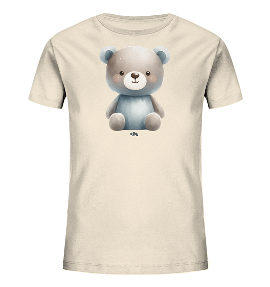 Onlineshop Shirts fuer Kinder - Das Bild zeigt ein cremefarbenes T-Shirt fuer Kinder. Auf der Vorderseite ist eine niedliche Illustration eines sitzenden Teddybaeren zu sehen. Der Baer hat ein freundliches Gesicht und ist in sanften Grau- und Blautoenen gehalten. Dieses Motiv verleiht dem Shirt einen verspielten Charakter.